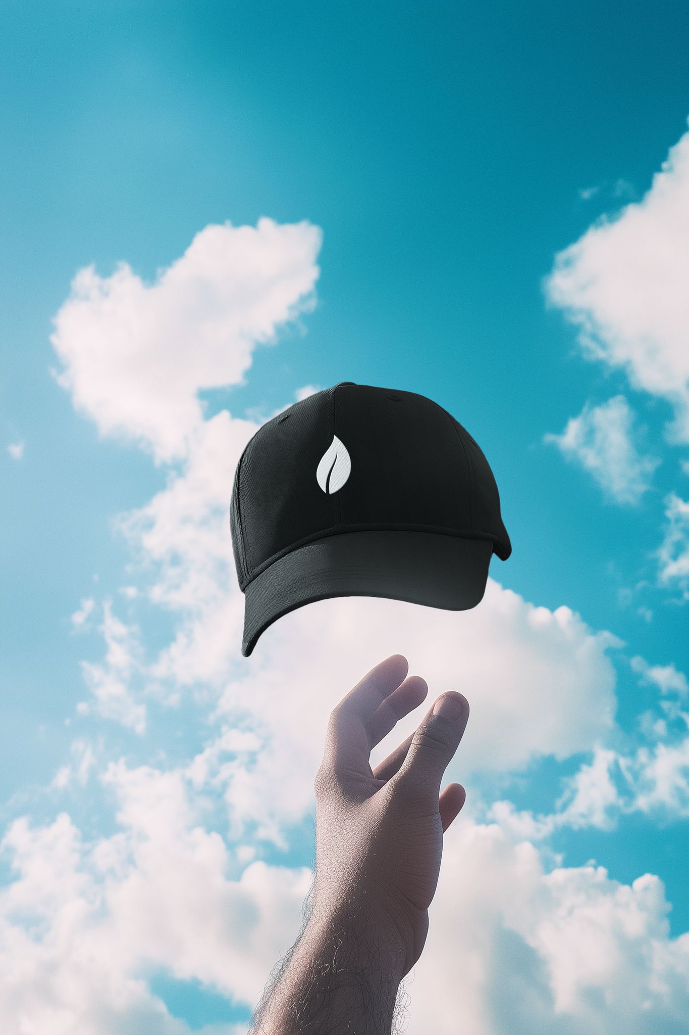 Hand reaching toward the Soft Armour Hat by Rtys3 — minimalist black cap with white leaf logo, floating against a sky of soft clouds